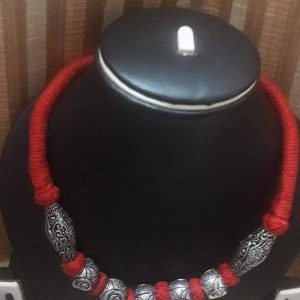 Red thread neck piece with silver beads