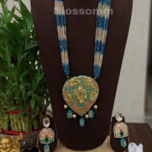 Pastel shade Meenakari Pendant with bunch of champagne and blue colour crystals